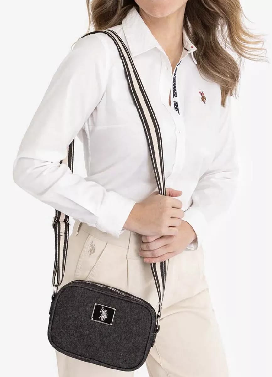 U.S. Polo Assn. Classic Zip Crossbody Bag in black denim with a striped web strap.