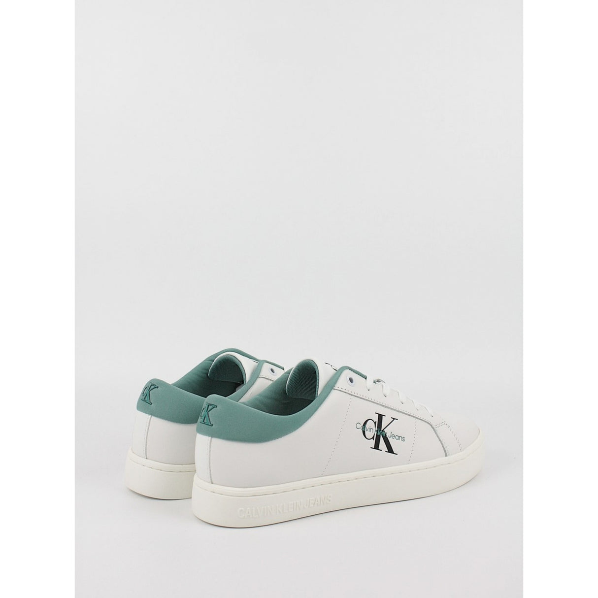 This is a pair of men's Calvin Klein Jeans Classic Cupsole Low Laceup sneakers in bright white leather with a turquoise/oil blue heel tab.