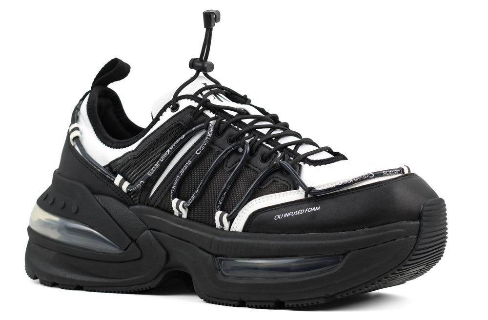 This is a Calvin Klein Chunky Comfair Low LTH MR sneaker in black and white.