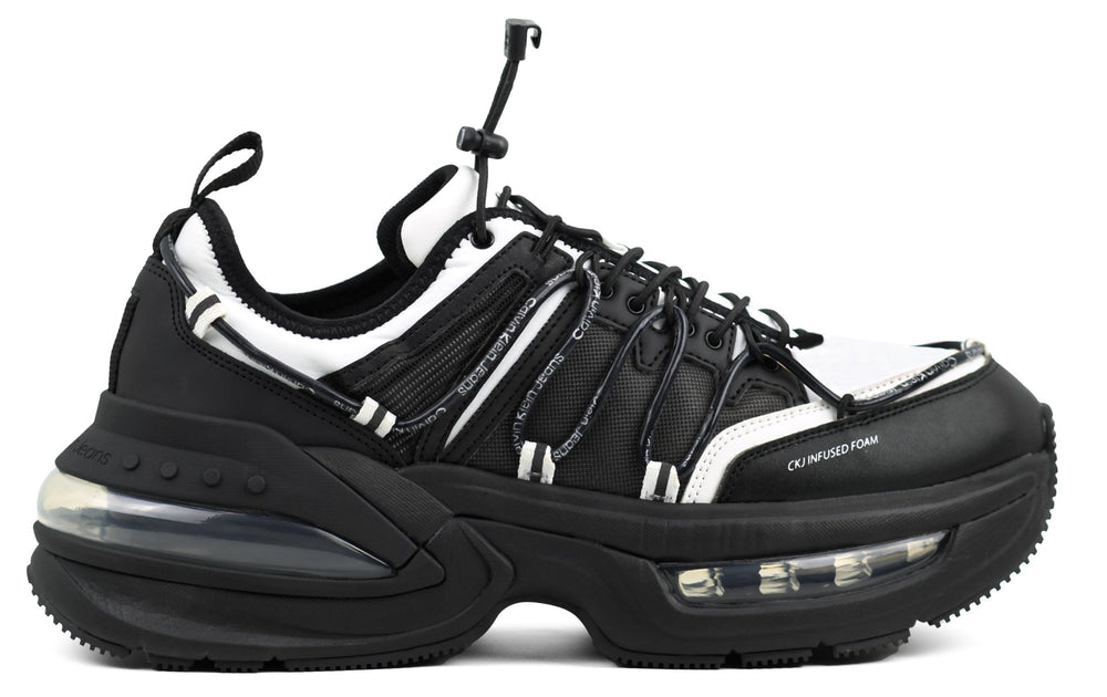 This is a Calvin Klein Chunky Comfair Low LTH MR sneaker in black and white.