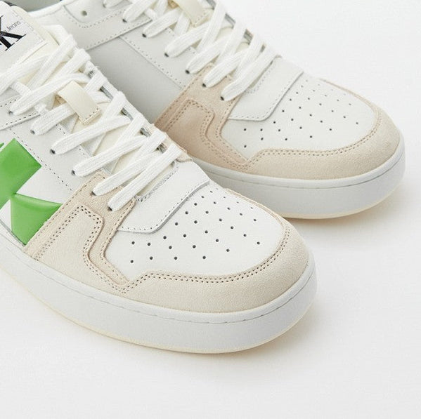 This is a pair of Calvin Klein low cupsole suede trainers in off white and green with a gum sole.