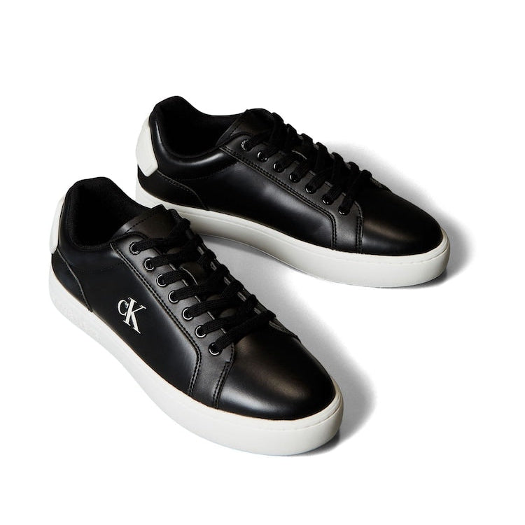 This is a pair of Calvin Klein Classic Cupsole Patch Leather sneakers in black and white.