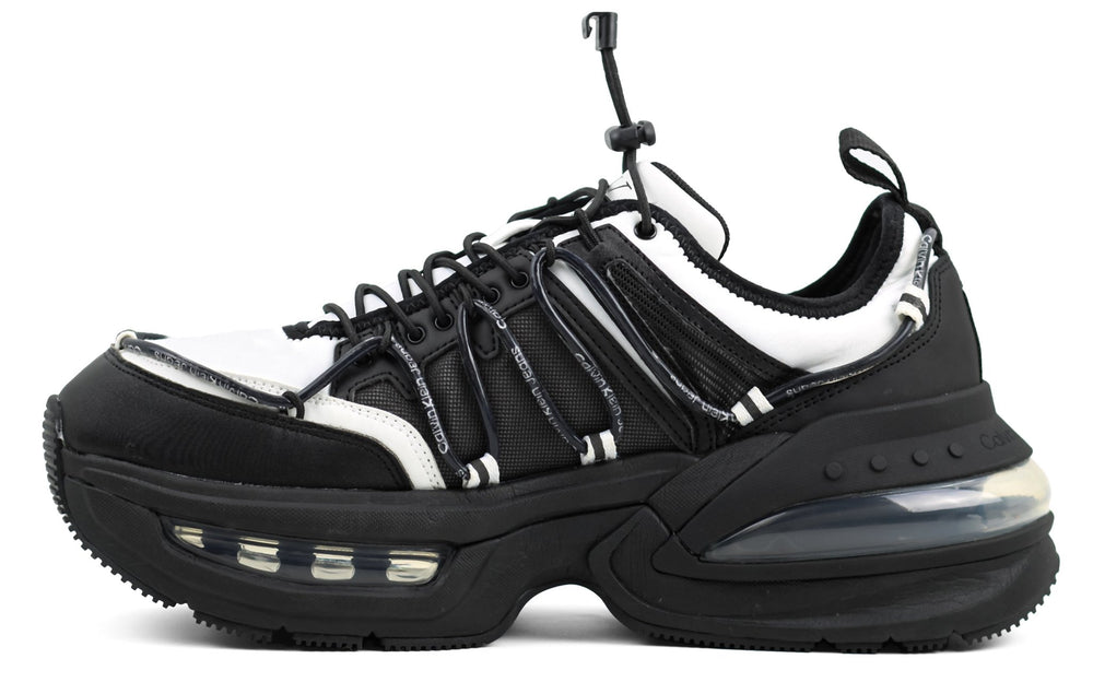 This is a Calvin Klein Chunky Comfair Low LTH MR sneaker in black and white.