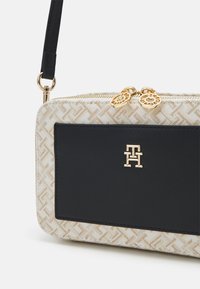 Tommy Hilfiger Women’s Beige & Black Crossbody Bag – Compact Elegance