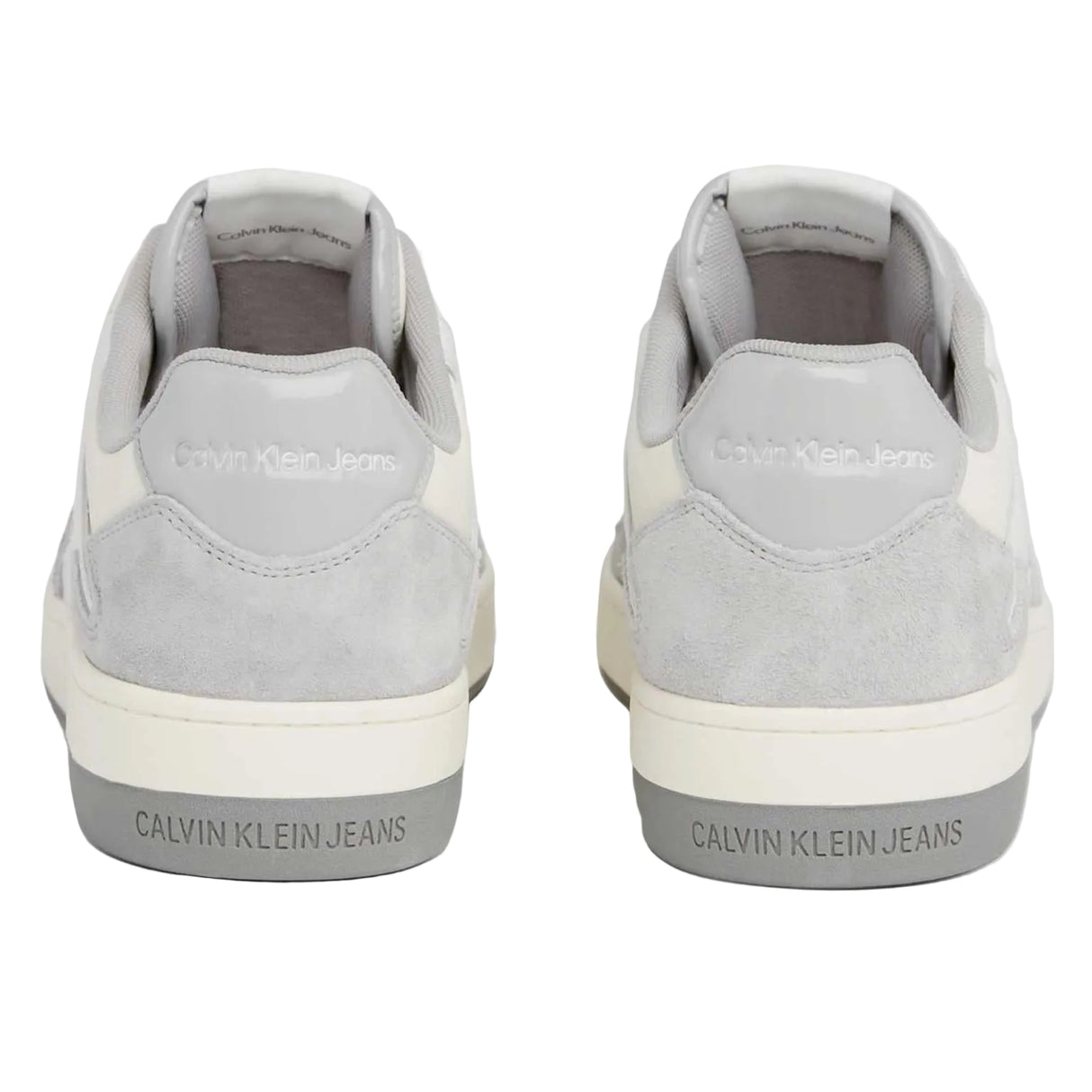 This is a pair of Calvin Klein Jeans Basket Cupsole Low sneakers in white and grey suede with red logo detail.